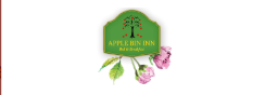 A green Apple Bin Inn sign with a red apple tree graphic, golden text, and pink flowers below on a white background.